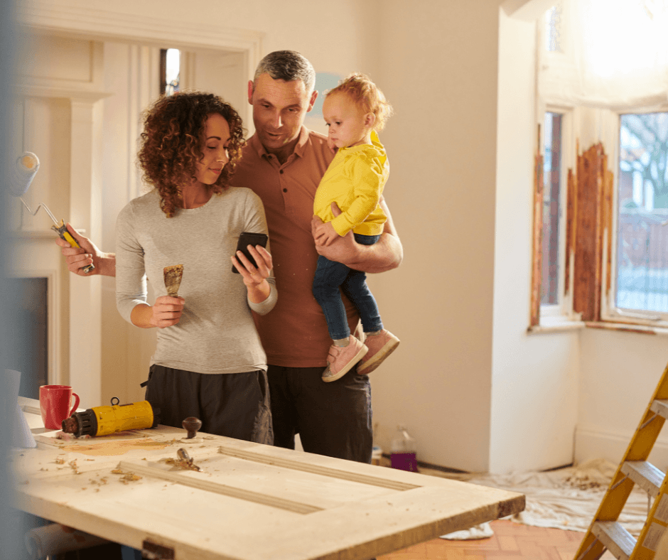 Young family planning home improvements with smartphone during renovation project