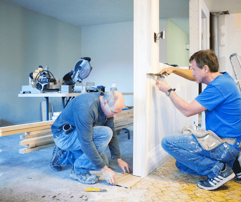 Two men installing trim and baseboards during home renovation work
